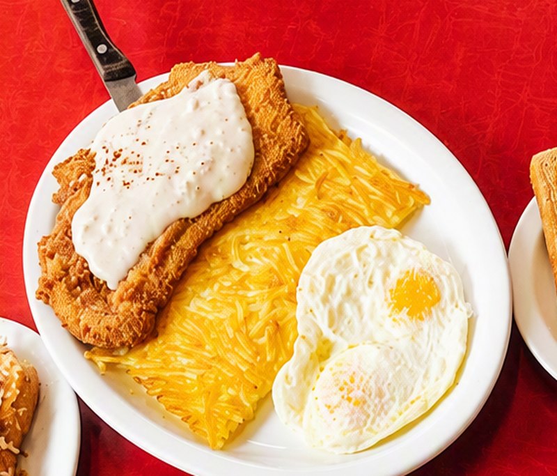 Chicken fried steak with eggs and hash browns
